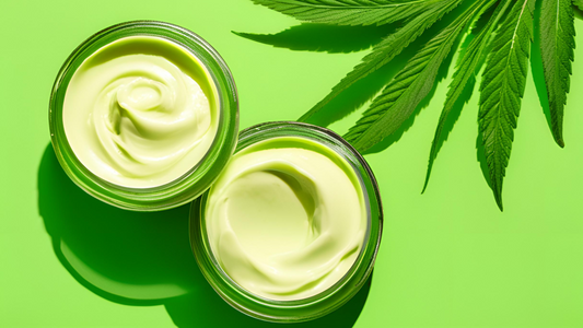 Two open jars of topical pain relief cream beside green leaves