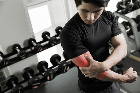 Person applying muscle relief cream to their arm after a workout